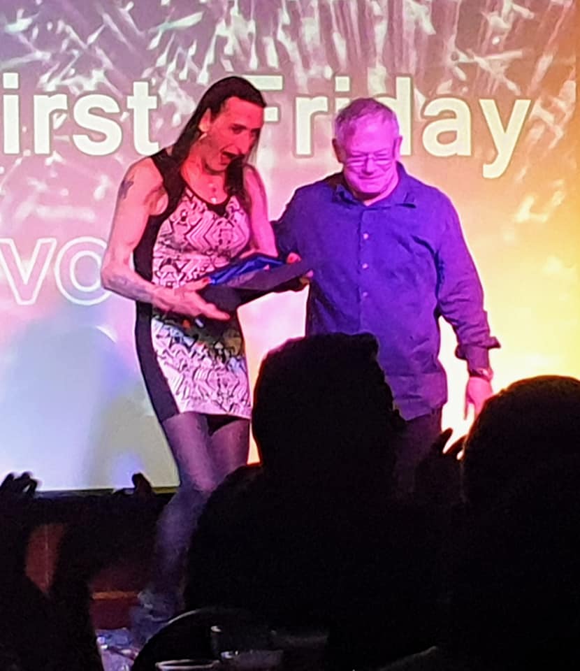 Janie accepting the 2019 Owlies award